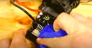 Rubbing electrical parts with wet cloth